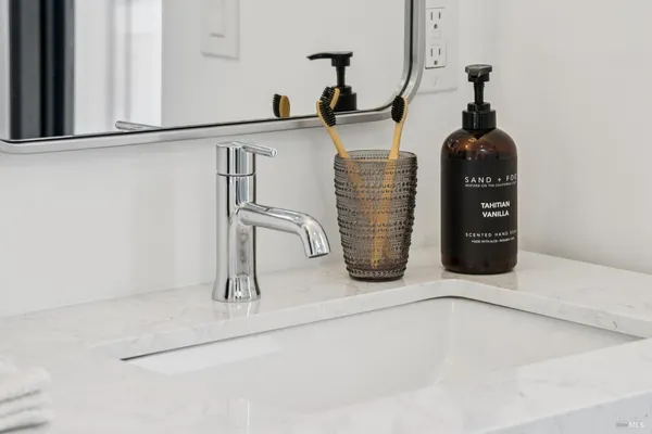 a view of a kitchen area with furniture and wooden floor