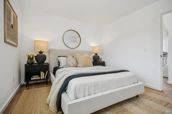 a bedroom with a bed and a large window