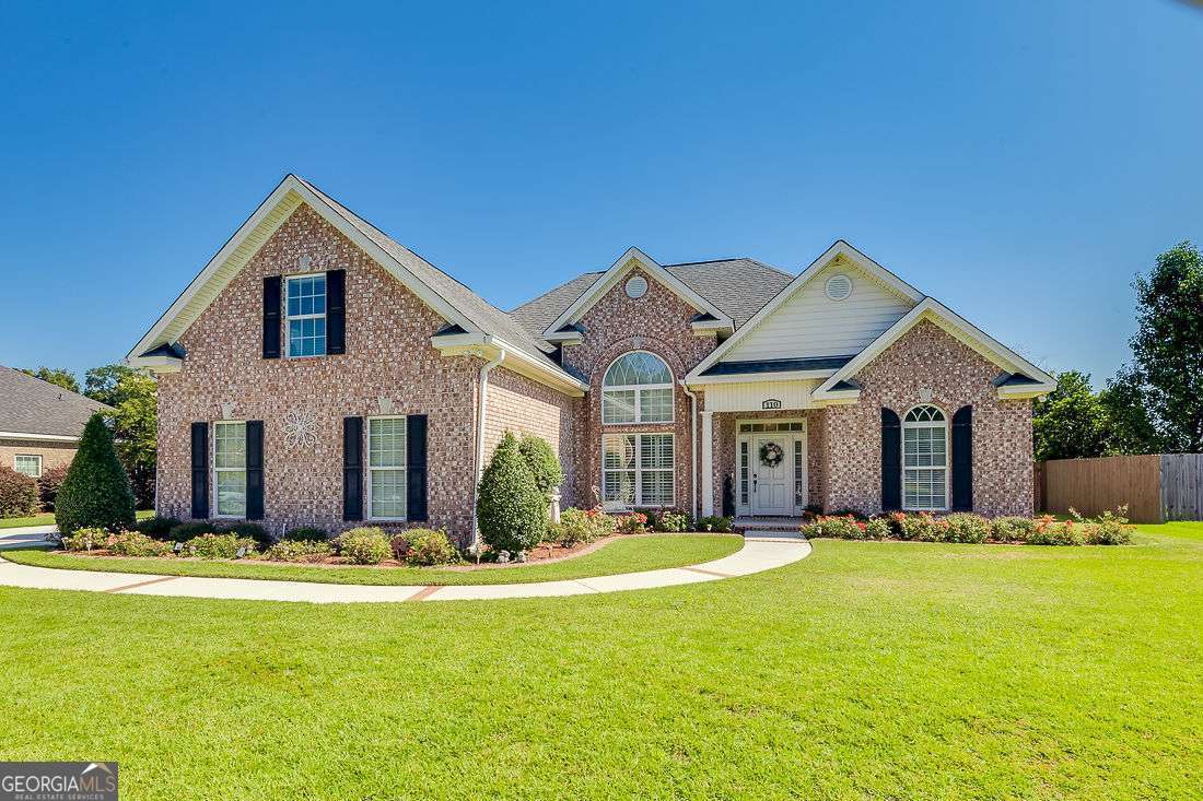 a front view of house with yard and trees