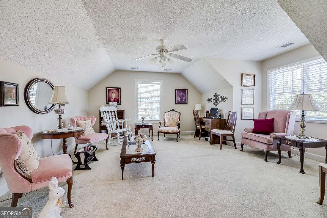110 Cobbleton Drive Rincon, GA 31326 - Photo 33 of 41 a living room with furniture and a mirror