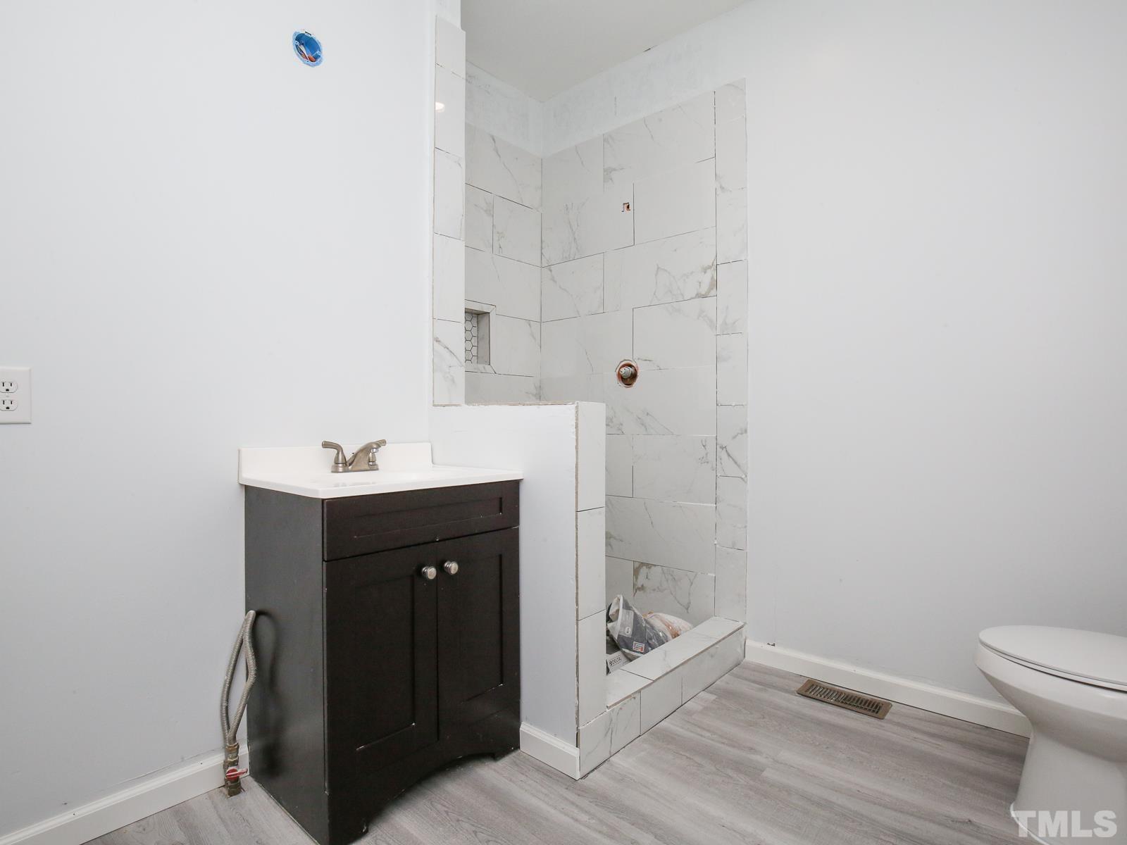 3305 Six Forks Road Raleigh, NC 27609 - Photo 24 of 30 This bath is attached to first floor bedroom. Just needs shower to be grouted and faucet installed then it will be a 3rd full bath in house.