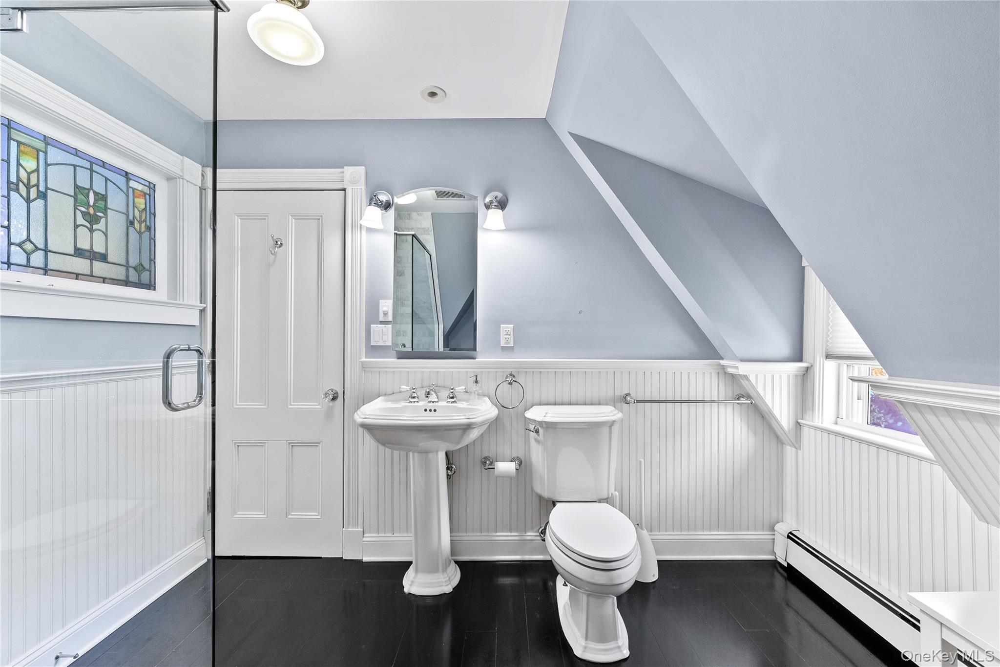 19 Howe Place Bronxville, NY 10708 - Photo 24 of 37 Bathroom featuring a pedestal sink, white toilet, and dark wood-finish flooring