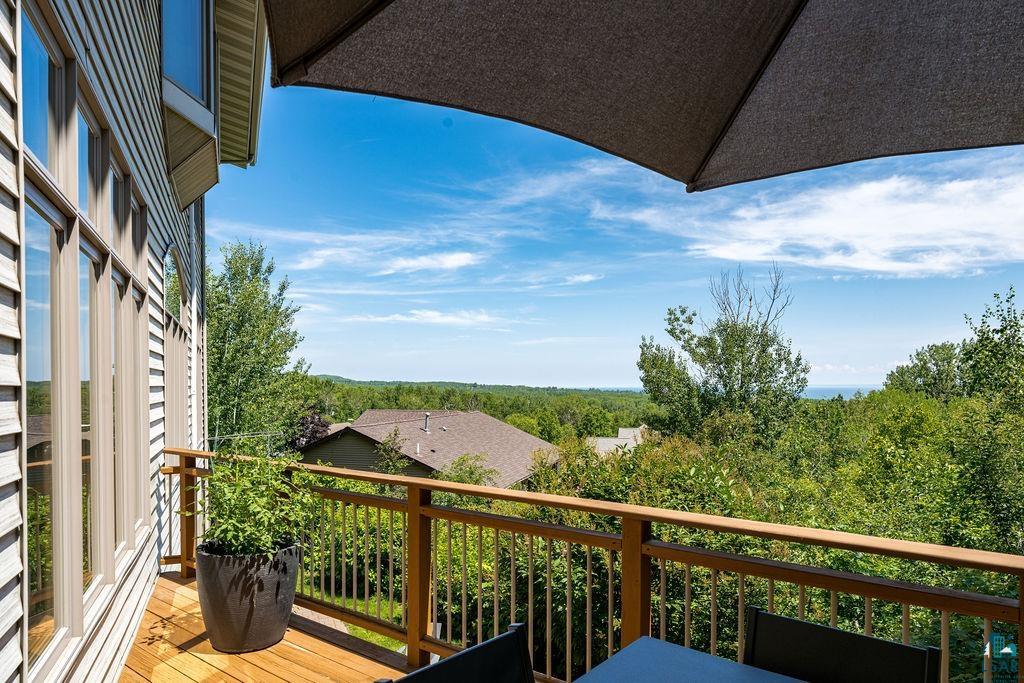4856 Kingston Street Duluth, MN 55804 - Photo 76 of 88 Expansive wood-finish deck with a wood-tone railing and broad-pane windows