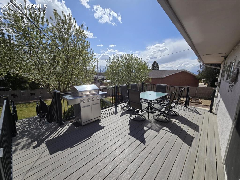 20 Robertson Road Pueblo, CO 81001 - Photo 29 of 39 a view of a deck with table and chairs under an umbrella with wooden floor