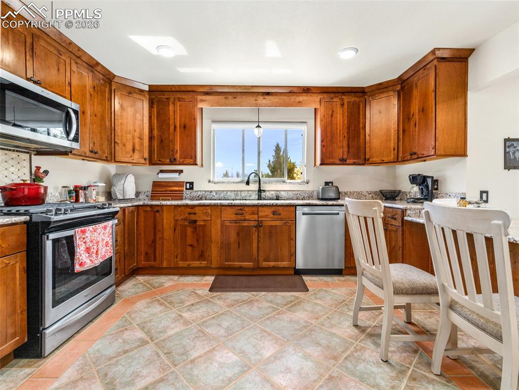 20 Robertson Road Pueblo, CO 81001 - Photo 5 of 39 a kitchen with a sink cabinets and window