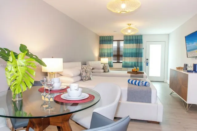 a dining room with furniture and a floor to ceiling window