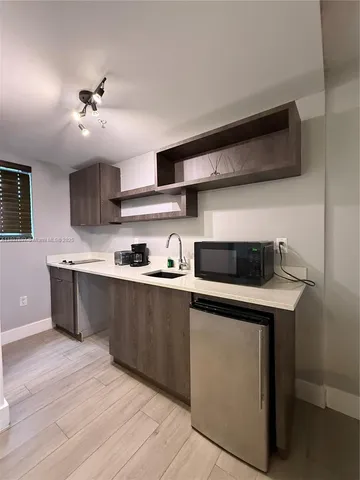 a kitchen with stainless steel appliances granite countertop a sink and a stove