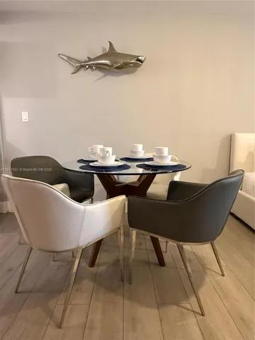 a table and chairs in a blue room