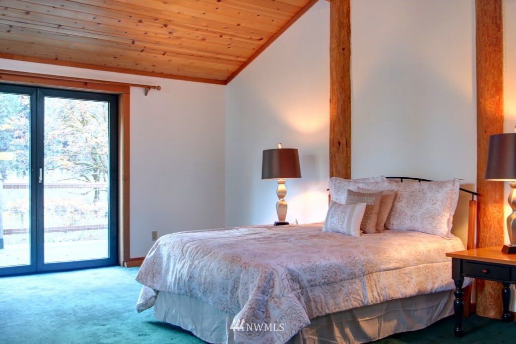 4567 Mosquito Lake Road Deming, WA 98244 - Photo 14 of 25 a bedroom with a bed and window