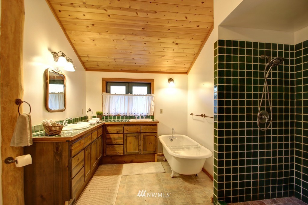4567 Mosquito Lake Road Deming, WA 98244 - Photo 16 of 25 a bathroom with a granite countertop toilet a sink and mirror