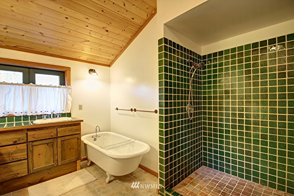 4567 Mosquito Lake Road Deming, WA 98244 - Photo 17 of 25 a bathroom with a granite countertop toilet a sink and a shower