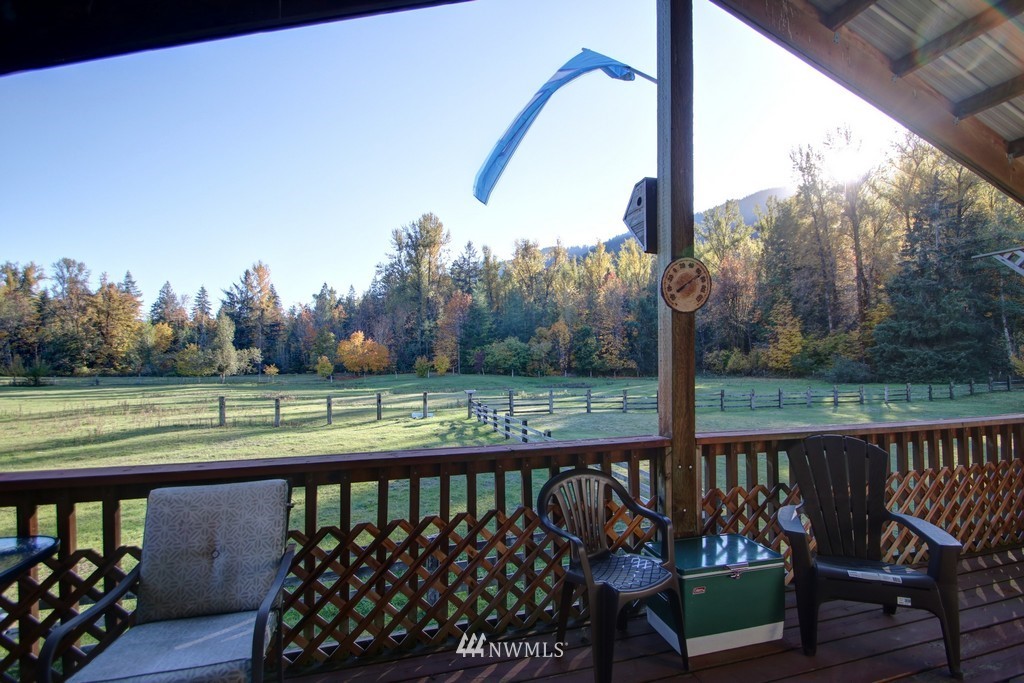 4567 Mosquito Lake Road Deming, WA 98244 - Photo 22 of 25 a view of a wooden deck with two chairs and a table