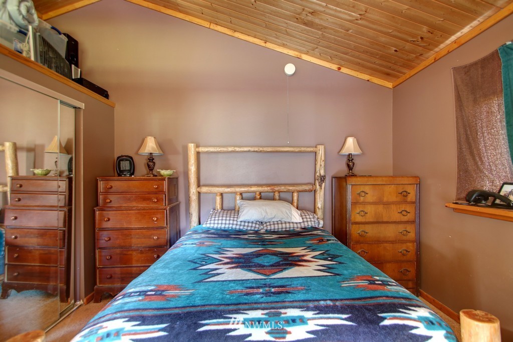 4567 Mosquito Lake Road Deming, WA 98244 - Photo 25 of 25 a bedroom with a bed and wooden floor