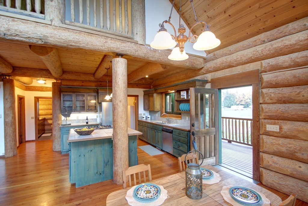 4567 Mosquito Lake Road Deming, WA 98244 - Photo 8 of 25 a view of a dining room with furniture a chandelier and wooden floor