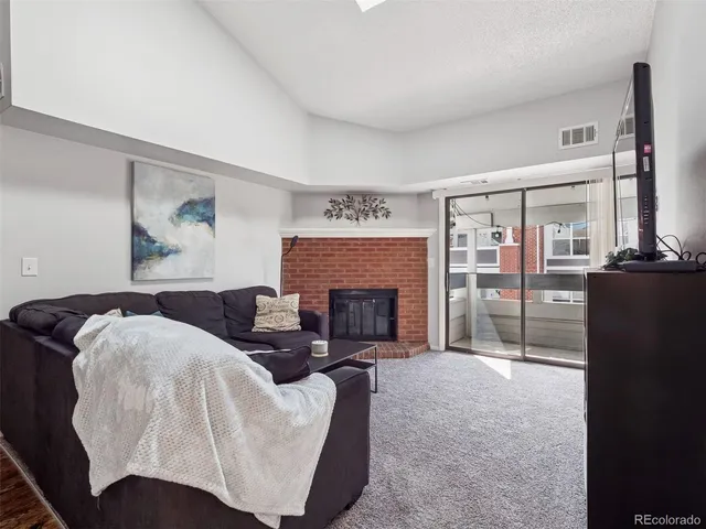 a living room with furniture a fireplace and a fireplace