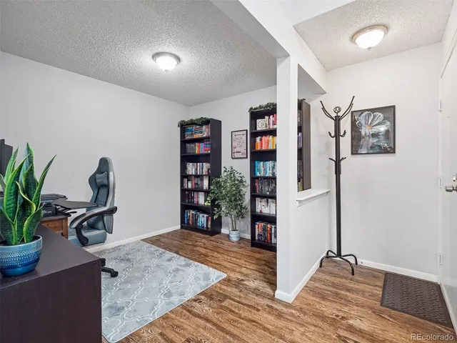 a view of a workspace with furniture and a potted plant