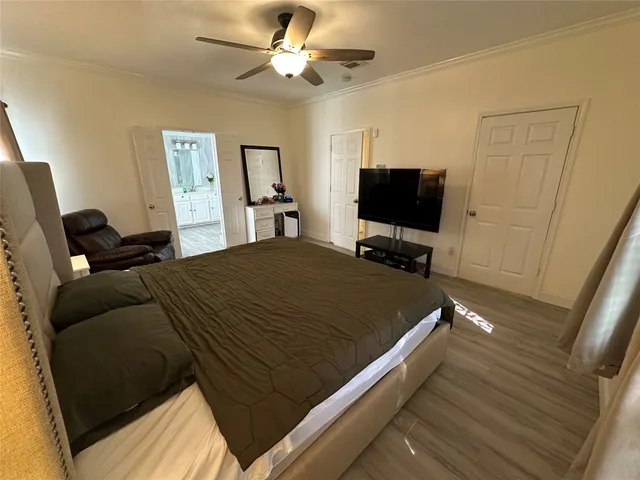 a bed room with a bed tv and a window