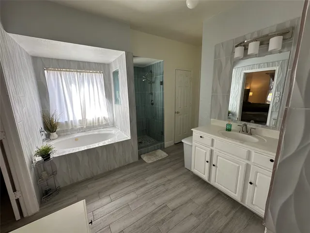 a room with two mirror and a dresser in it