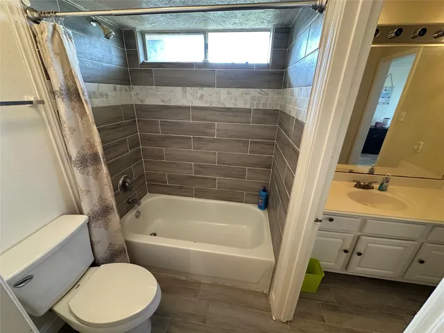 a bathroom with a toilet and a tub