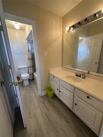 a bathroom with a double vanity sink and mirror with shower