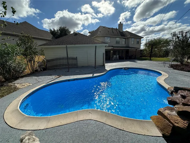 a view of a swimming pool with a lounge chairs