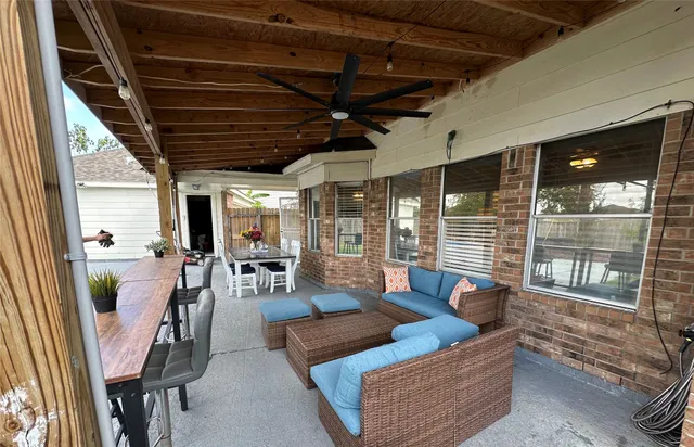 a view of a patio with a table chairs and a backyard