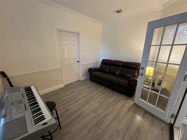 a living room with furniture and a piano