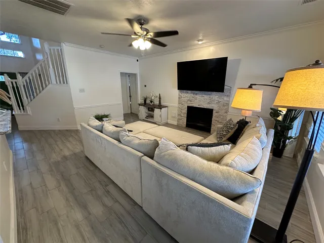 a living room with furniture a fireplace and a flat screen tv