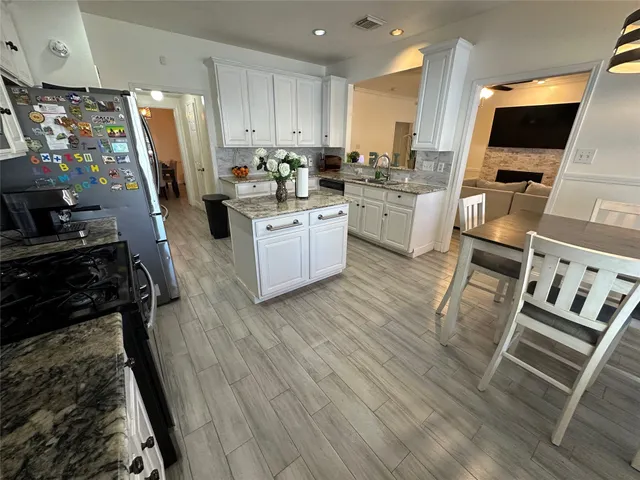 a kitchen with a sink appliances and cabinets