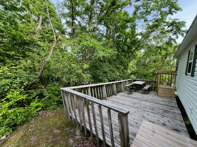 a view of balcony with wooden floor and fence