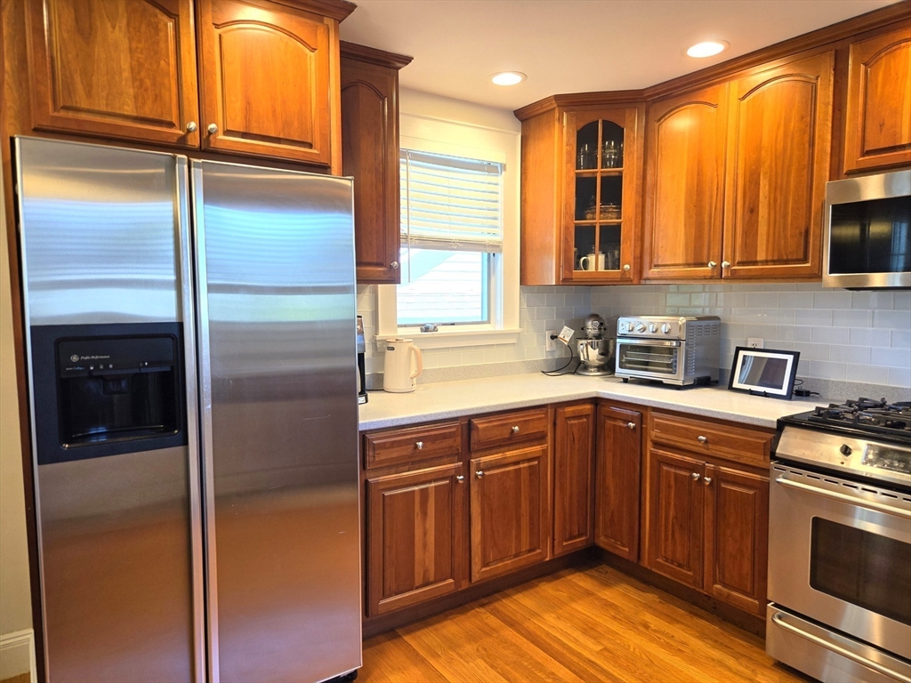 25 Waldeck Road Milton, MA 02186 - Photo 11 of 34 a kitchen with a refrigerator sink and cabinets