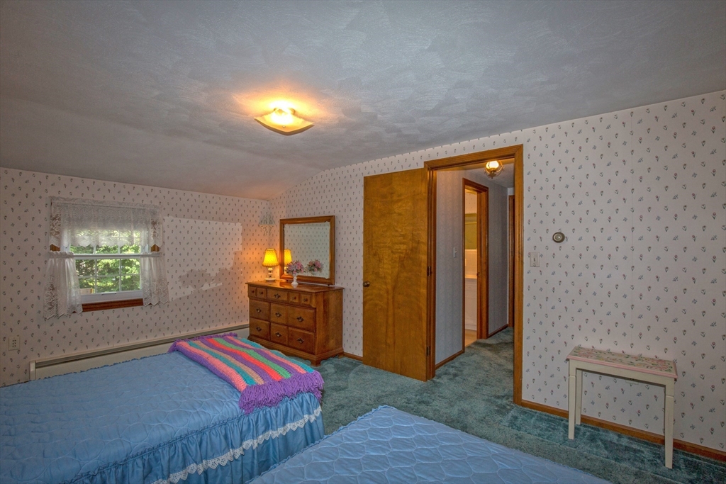 176 Wolf Swamp Road Longmeadow, MA 01106 - Photo 28 of 40 a bedroom with a bed and a lamp with window