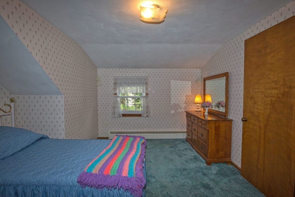 176 Wolf Swamp Road Longmeadow, MA 01106 - Photo 29 of 40 a room that has a bed and a mirror in it