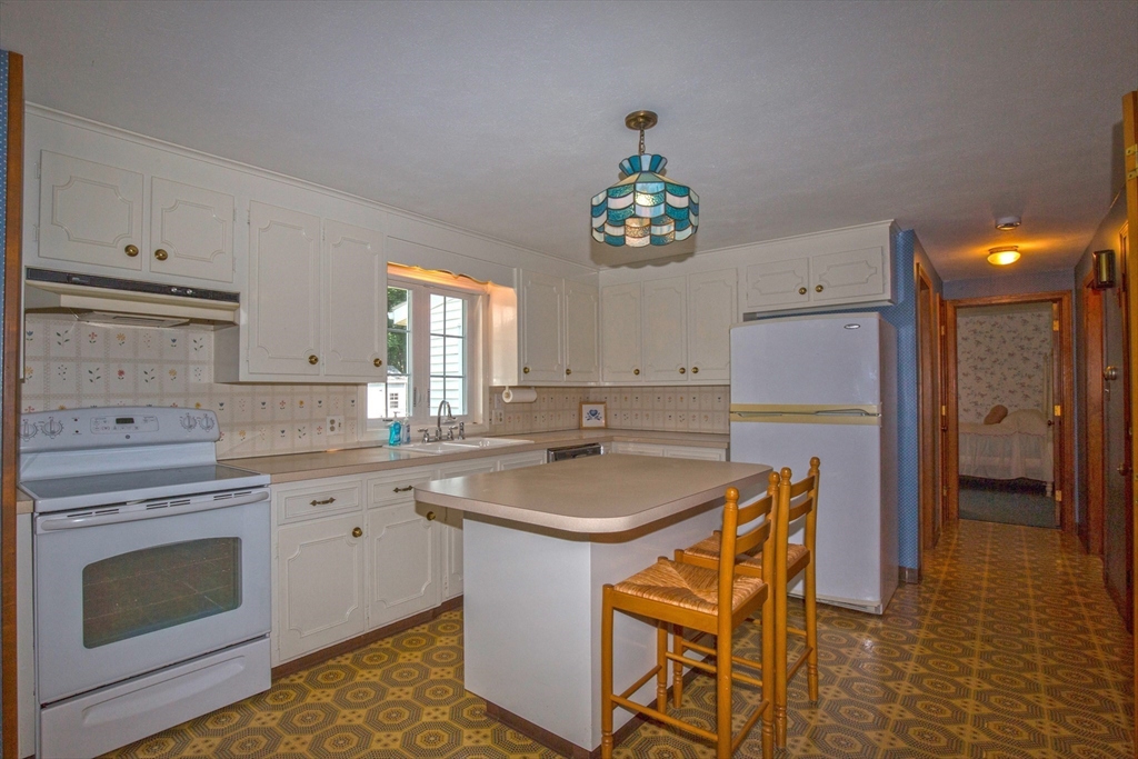 176 Wolf Swamp Road Longmeadow, MA 01106 - Photo 9 of 40 a kitchen with a sink a stove cabinets and counter space