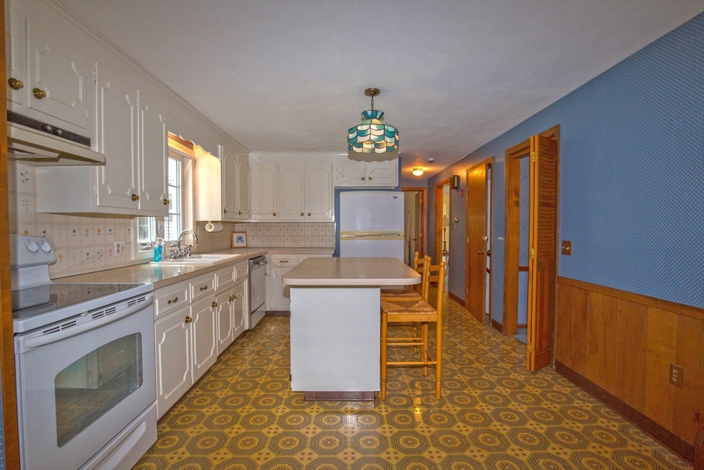 176 Wolf Swamp Road Longmeadow, MA 01106 - Photo 10 of 40 a kitchen with stainless steel appliances granite countertop a stove a sink dishwasher and a refrigerator