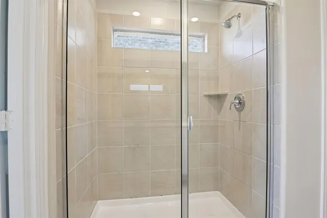 a bathroom with a glass shower door