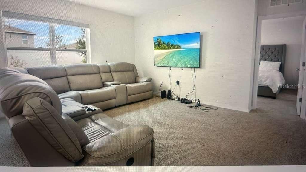 1872 Rustic Falls Drive Kissimmee, FL 34744 - Photo 16 of 30 a living room with furniture and a flat screen tv