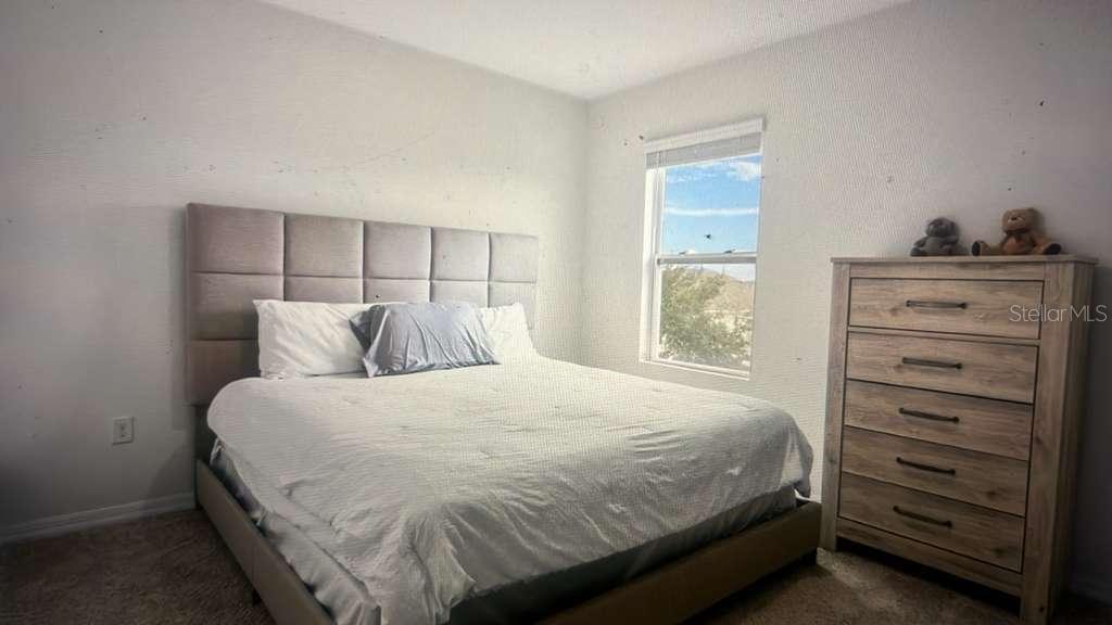 1872 Rustic Falls Drive Kissimmee, FL 34744 - Photo 19 of 30 a bedroom with a bed and a window
