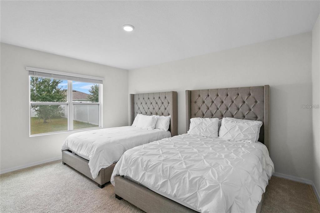 1872 Rustic Falls Drive Kissimmee, FL 34744 - Photo 23 of 30 a bedroom with two beds and a window