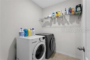 1872 Rustic Falls Drive Kissimmee, FL 34744 - Photo 25 of 30 a utility room with dryer and washer