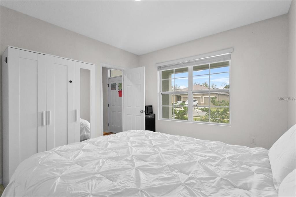1872 Rustic Falls Drive Kissimmee, FL 34744 - Photo 10 of 30 a view of a bedroom with wooden floor and a window