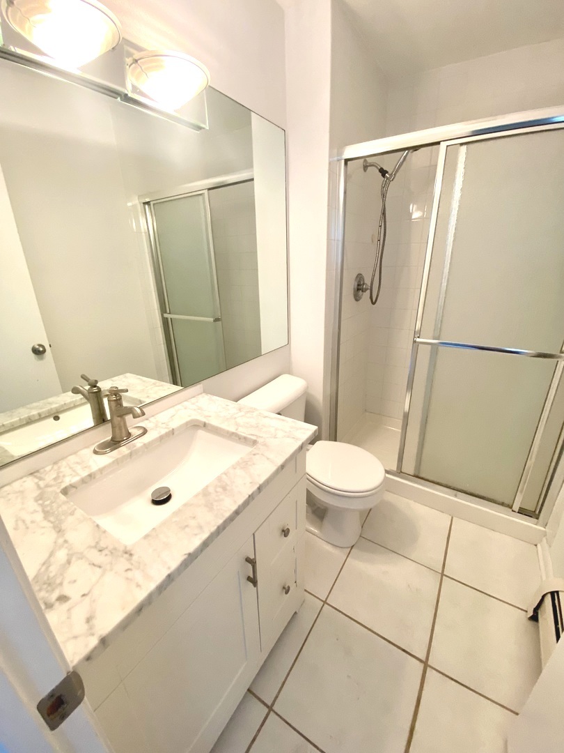 1149 Miller Lane, Unit 212 Buffalo Grove, IL 60089 - Photo 14 of 20 a bathroom with a sink and shower