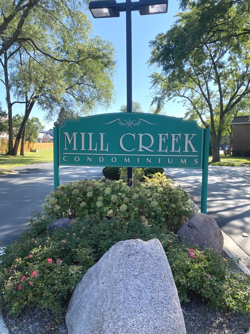 1149 Miller Lane, Unit 212 Buffalo Grove, IL 60089 - Photo 2 of 20 a view of a street with a building and trees