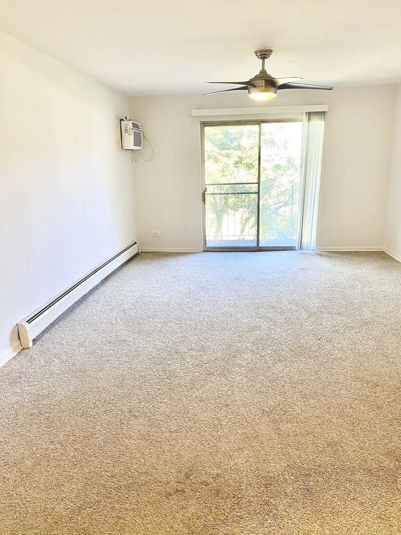 1149 Miller Lane, Unit 212 Buffalo Grove, IL 60089 - Photo 3 of 20 an empty room with windows and closet
