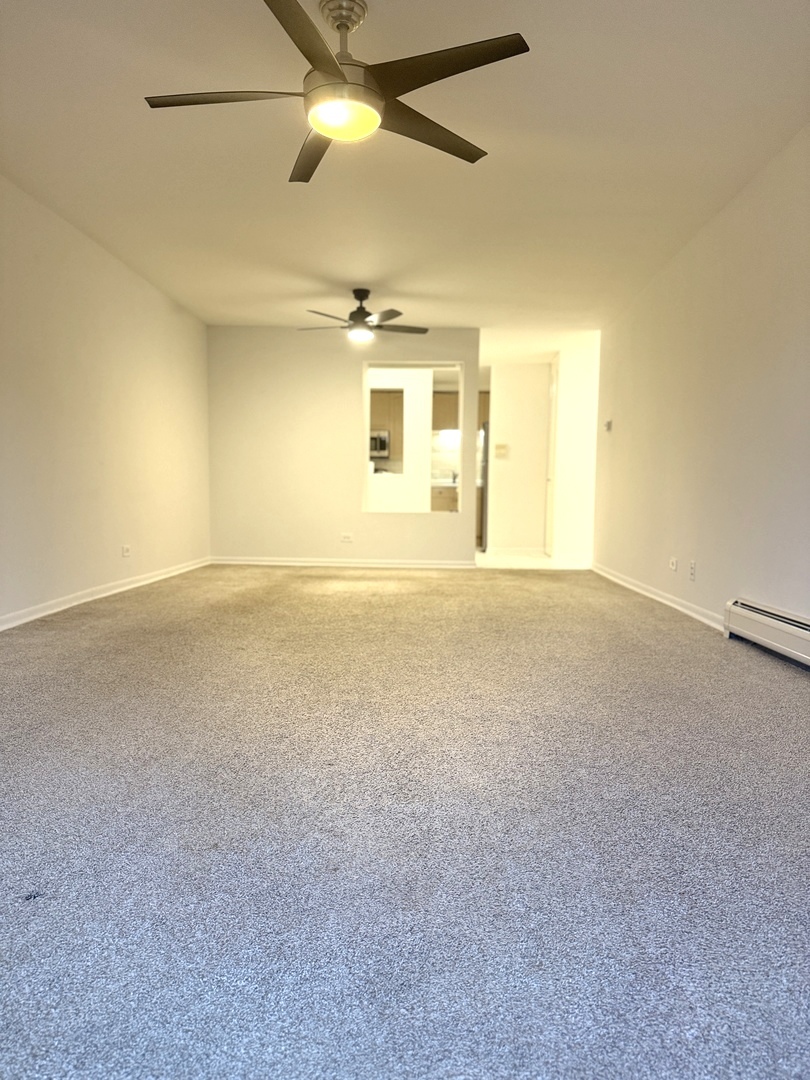 1149 Miller Lane, Unit 212 Buffalo Grove, IL 60089 - Photo 5 of 20 a view of an empty room with a window
