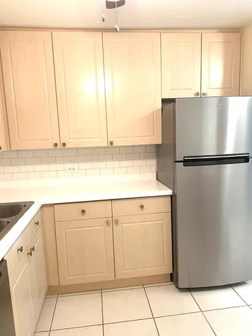 a white refrigerator freezer sitting in a kitchen