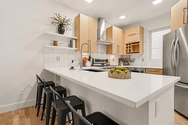 a kitchen with kitchen island a table and chairs