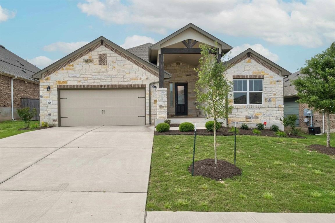 Beautiful front of home with driveway and covered front porch