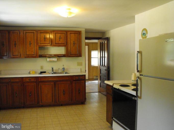 116 Paw Paw Road North Bloomery, WV 26817 - Photo 4 of 16 a kitchen with stainless steel appliances granite countertop a refrigerator and a sink