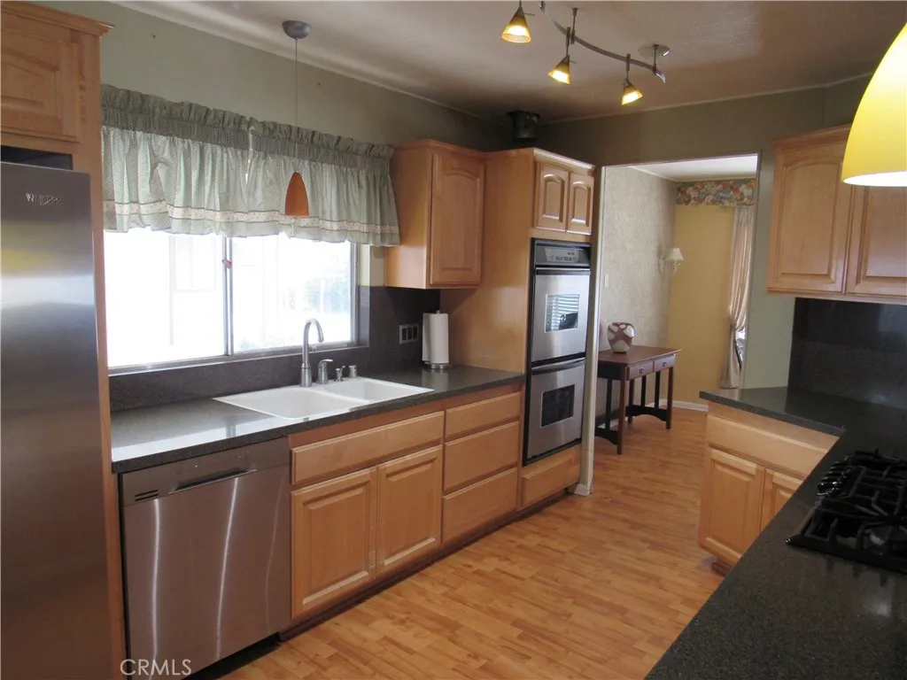 27701 Murrieta Road, Unit 6 Menifee, CA 92586 - Photo 13 of 28 a kitchen with stainless steel appliances granite countertop a sink stove and refrigerator